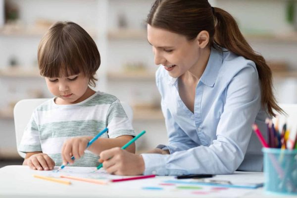 happy-woman-teacher-exercising-with-little-student-happy-boy-coloring-pictures-enjoying-development happy-woman-teacher-exercising-with-little-student-happy-boy-coloring-pictures-enjoying-development