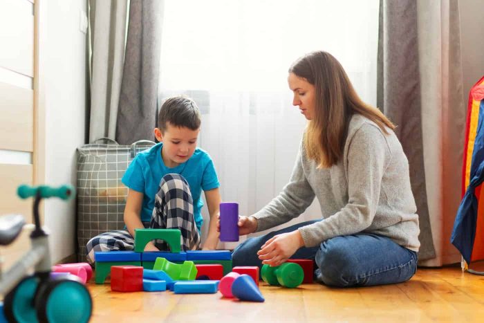 young-mother-her-son-playing-together-with-colorful-blocks young-mother-her-son-playing-together-with-colorful-blocks
